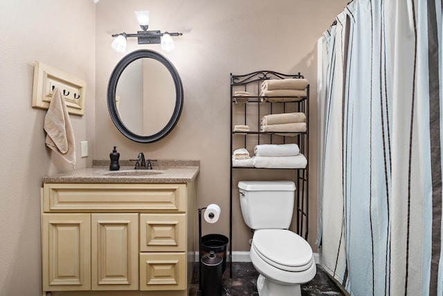 bathroom featuring vanity and toilet