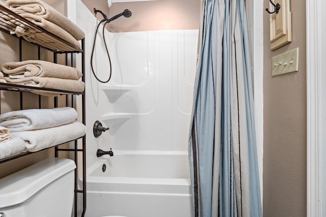 bathroom featuring toilet and shower / tub combo with curtain