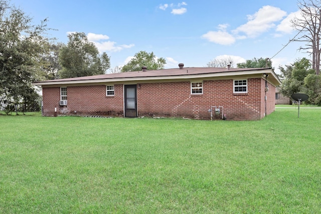 rear view of property with a lawn