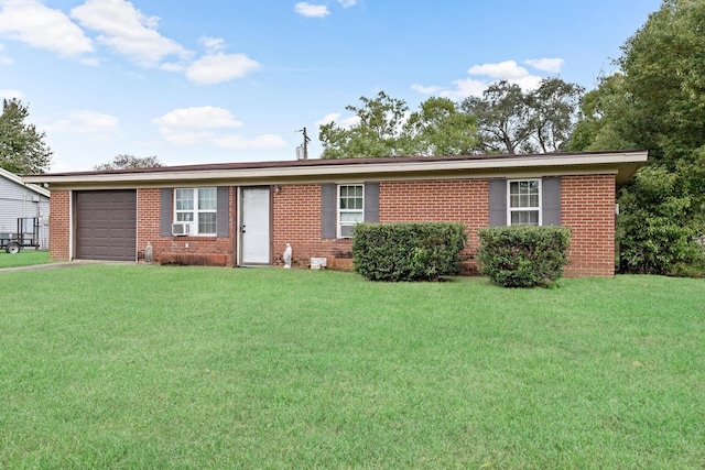 ranch-style home featuring a front lawn and a garage