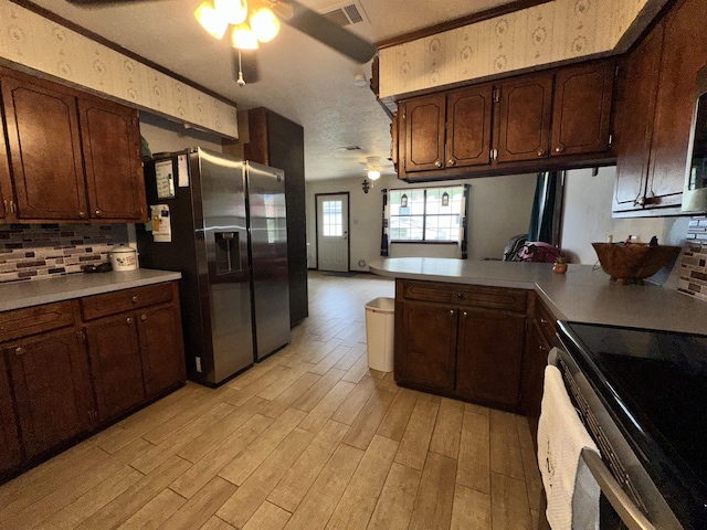 kitchen with light countertops, a ceiling fan, appliances with stainless steel finishes, visible vents, and light wood-style floors
