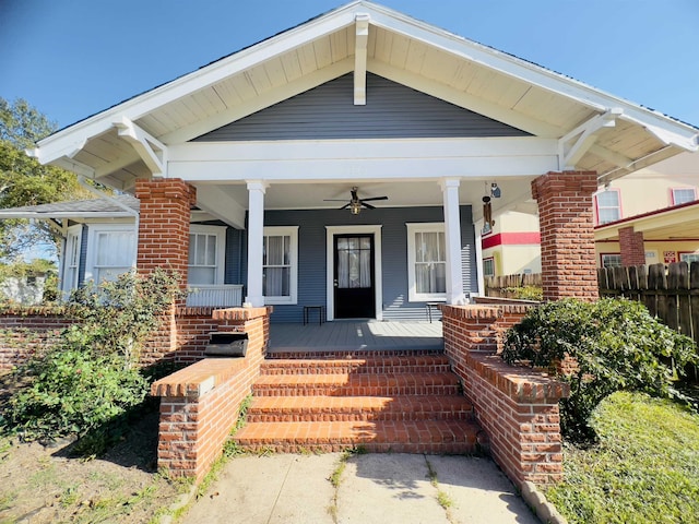 view of exterior entry featuring covered porch and ceiling fan