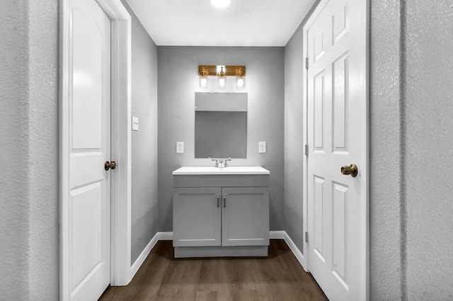 347 W Texas State Highway 63, Jasper, TX 75951 - bathroom with wood finished floors, baseboards, vanity, and a textured wall