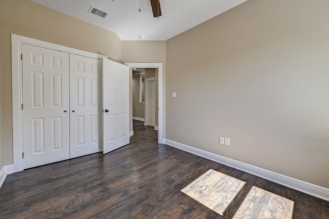 unfurnished bedroom with ceiling fan, a closet, and dark hardwood / wood-style floors