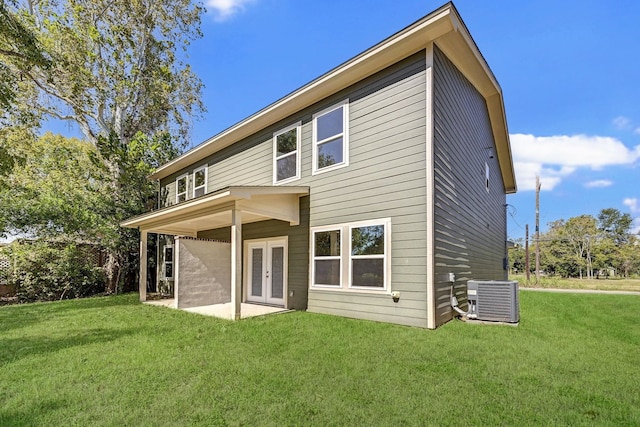 back of house with a lawn, a patio area, central air condition unit, and french doors