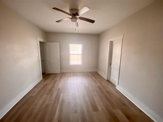 unfurnished bedroom featuring hardwood / wood-style flooring and ceiling fan