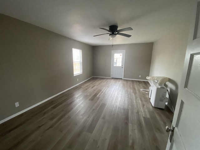 unfurnished room featuring dark hardwood / wood-style floors and ceiling fan