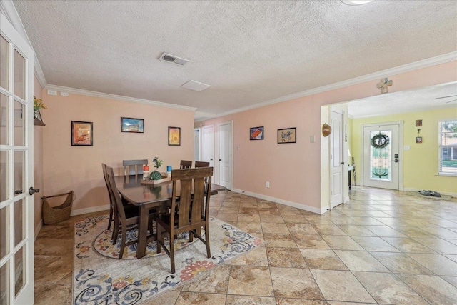 319 Dixie Dr, Bridge City, TX 77611 - dining area with french doors, crown molding, baseboards, a textured ceiling, and light stone finish floors
