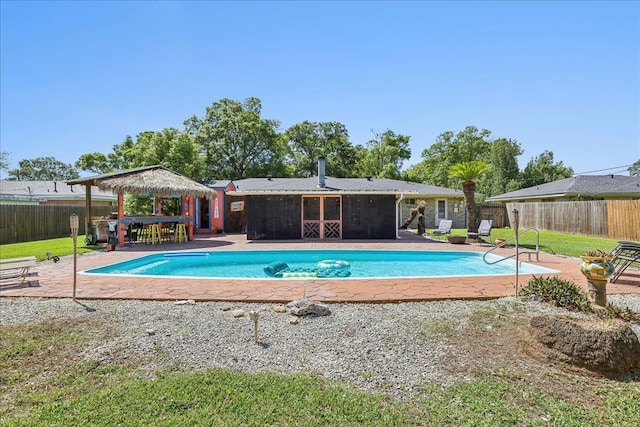 319 Dixie Dr, Bridge City, TX 77611 - view of pool with a fenced backyard, a patio area, and a sunroom