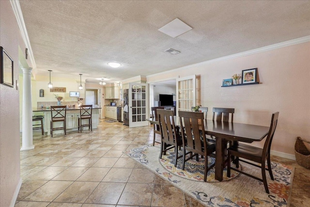 319 Dixie Dr, Bridge City, TX 77611 - dining space with ornamental molding, decorative columns, a textured ceiling, and baseboards