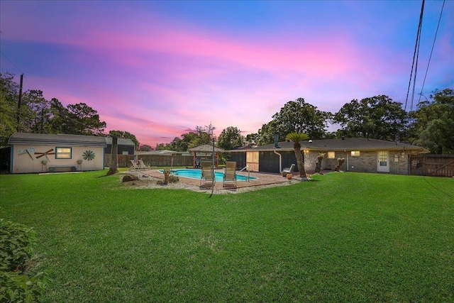 319 Dixie Dr, Bridge City, TX 77611 - yard at dusk with an outdoor structure