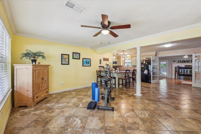 319 Dixie Dr, Bridge City, TX 77611 - workout area featuring ceiling fan, ornamental molding, decorative columns, baseboards, and a textured ceiling