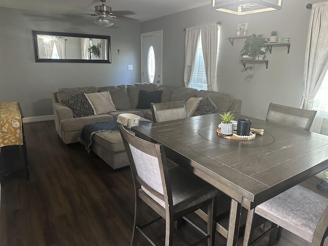 dining space with ceiling fan and dark hardwood / wood-style flooring