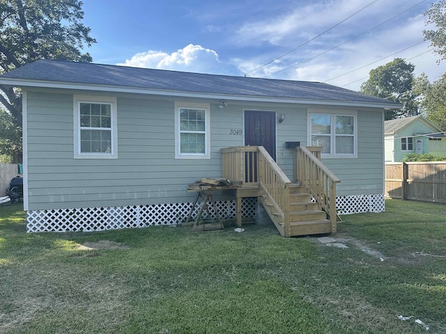 rear view of property featuring a yard