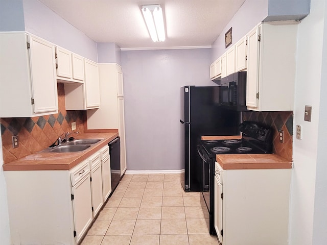 kitchen featuring black appliances, sink, tasteful backsplash, light tile patterned flooring, and white cabinetry