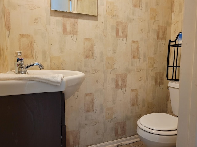 bathroom with tile patterned floors, vanity, and toilet