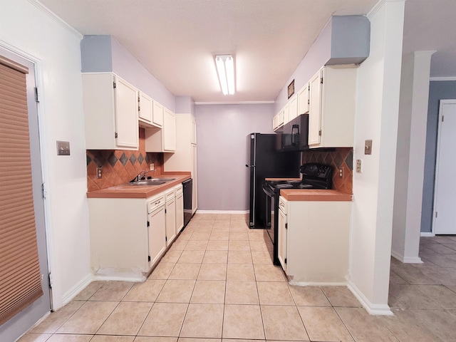 kitchen featuring sink, crown molding, decorative backsplash, white cabinets, and black appliances