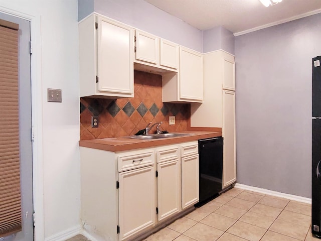 kitchen with dishwasher, white cabinets, sink, tasteful backsplash, and light tile patterned flooring