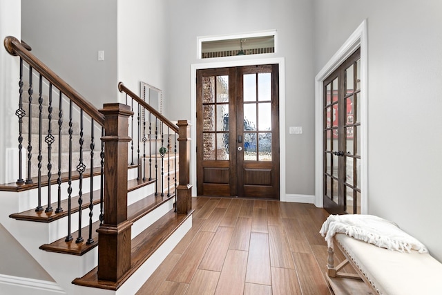 entrance foyer featuring french doors and light hardwood / wood-style flooring