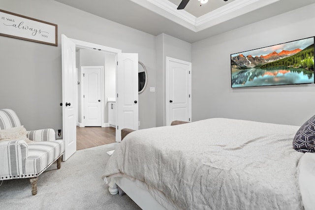 bedroom with ceiling fan, a raised ceiling, and ornamental molding