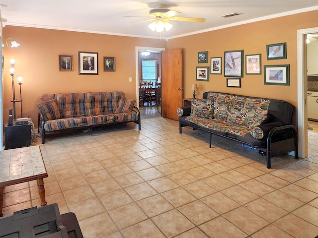 living room with light tile patterned floors, ornamental molding, a ceiling fan, and visible vents