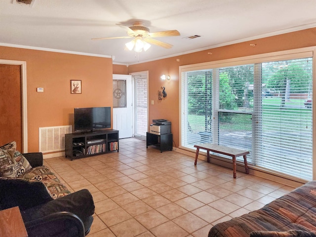 living area featuring visible vents, a ceiling fan, crown molding, and light tile patterned floors