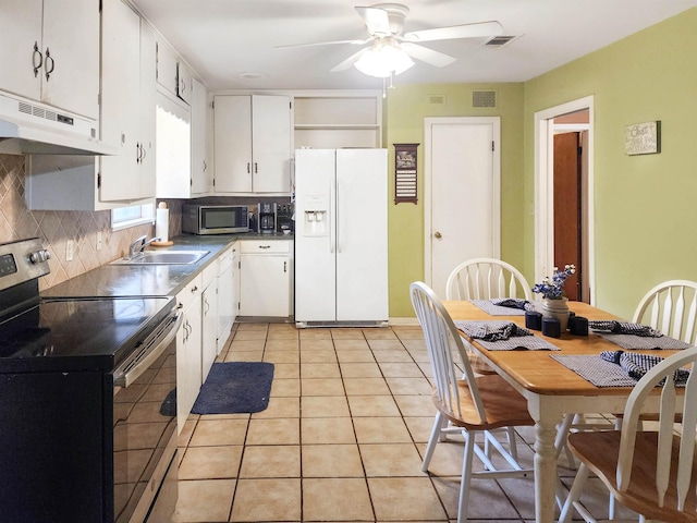 kitchen featuring a sink, white cabinetry, under cabinet range hood, and stainless steel appliances