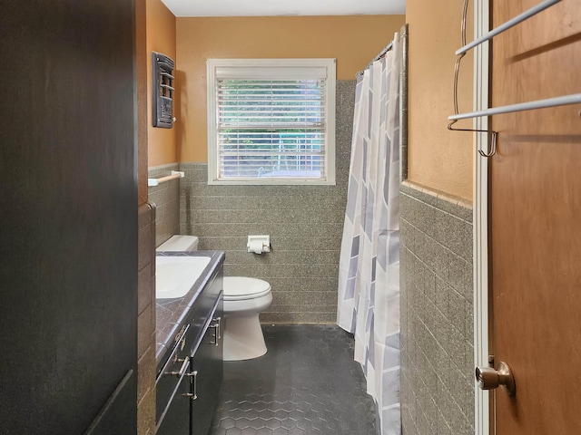 full bath featuring wainscoting, vanity, toilet, tile walls, and curtained shower