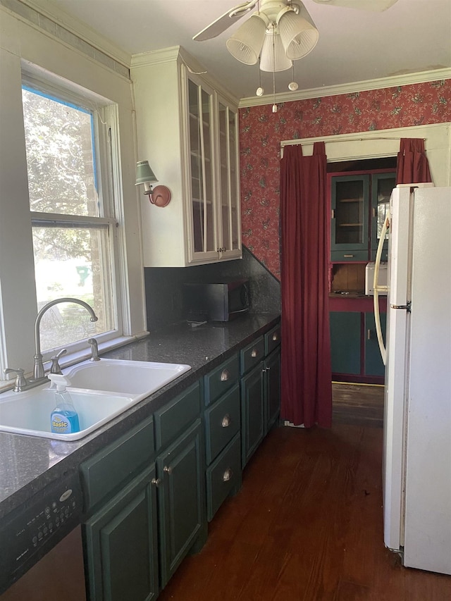 kitchen featuring sink, dark wood-type flooring, stainless steel dishwasher, white refrigerator, and ornamental molding