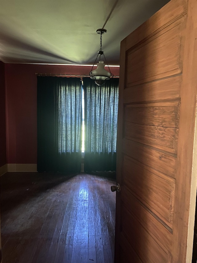 unfurnished dining area with dark hardwood / wood-style floors