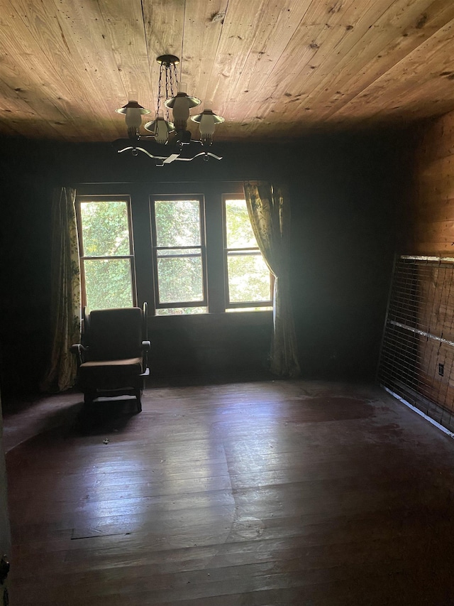 unfurnished room with dark wood-type flooring, plenty of natural light, wooden ceiling, and an inviting chandelier