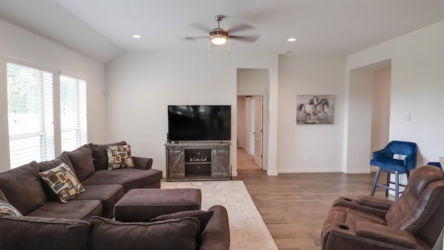 living room featuring hardwood / wood-style flooring, vaulted ceiling, and ceiling fan