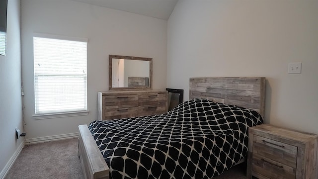 carpeted bedroom featuring lofted ceiling