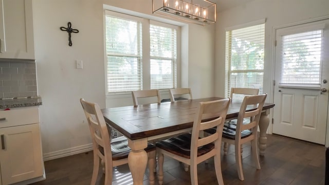 dining space featuring a chandelier, dark hardwood / wood-style floors, and plenty of natural light