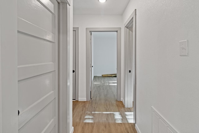 hallway with light wood-type flooring