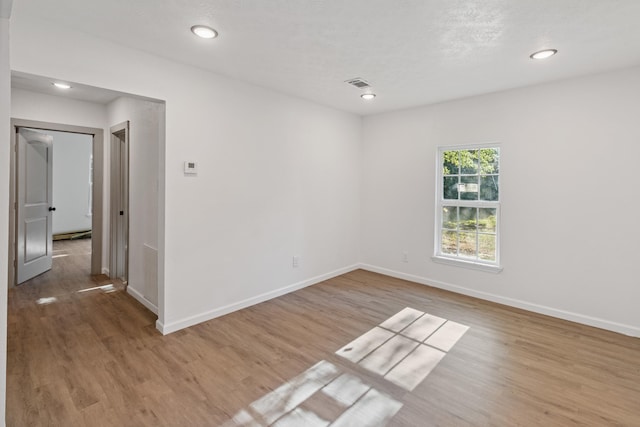 unfurnished room featuring light hardwood / wood-style floors