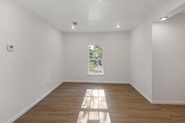 spare room featuring dark hardwood / wood-style floors