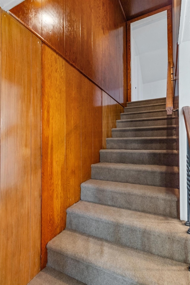 stairs featuring wooden walls