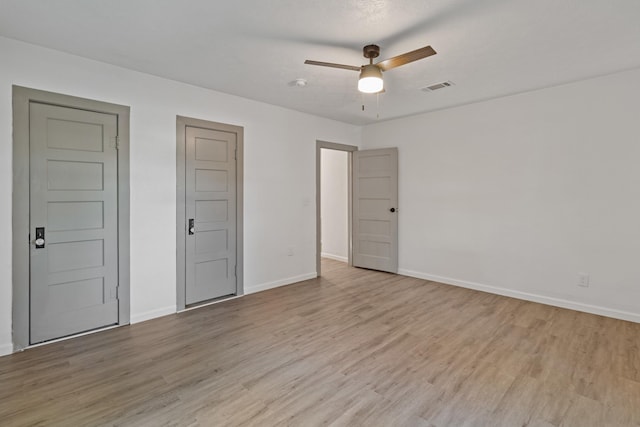 unfurnished bedroom with ceiling fan and light hardwood / wood-style floors