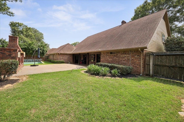 1550 Belvedere Dr, Beaumont, TX 77706 - rear view of house featuring brick siding, a patio, and roof with shingles