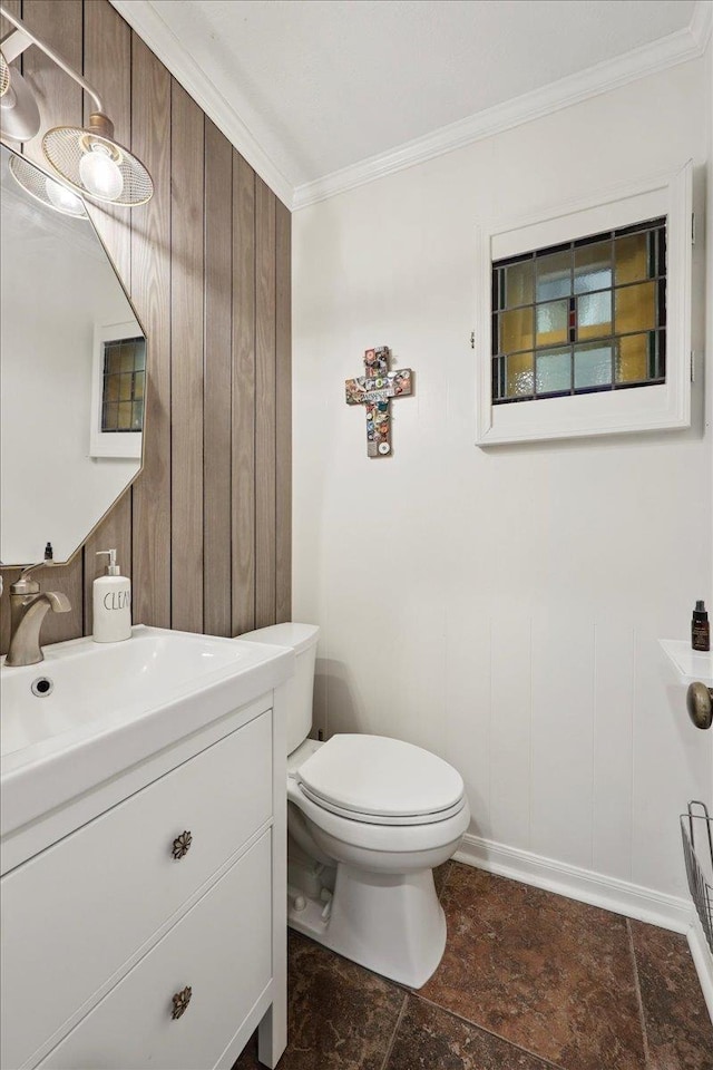 1550 Belvedere Dr, Beaumont, TX 77706 - bathroom featuring crown molding, vanity, toilet, and wood walls