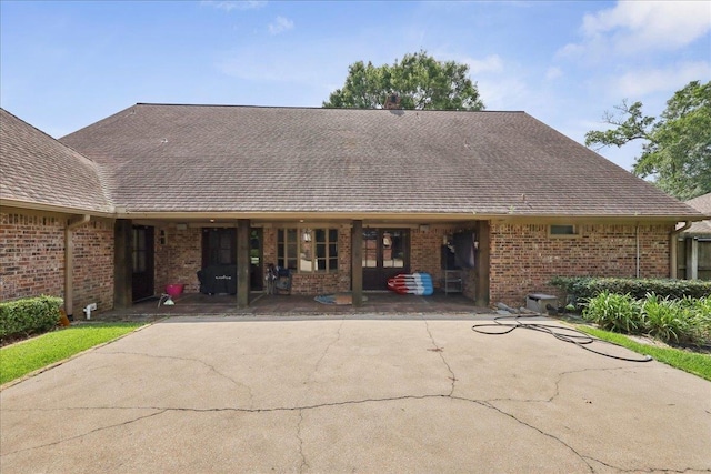 1550 Belvedere Dr, Beaumont, TX 77706 - rear view of house with brick siding and roof with shingles