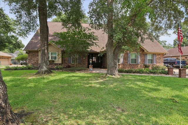 1550 Belvedere Dr, Beaumont, TX 77706 - view of front facade featuring brick siding, a front lawn, and a shingled roof