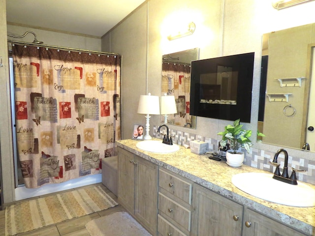 14547 Oak Leaf Loop, Splendora, TX 77372 - bathroom featuring double vanity, decorative backsplash, and shower / bath combo