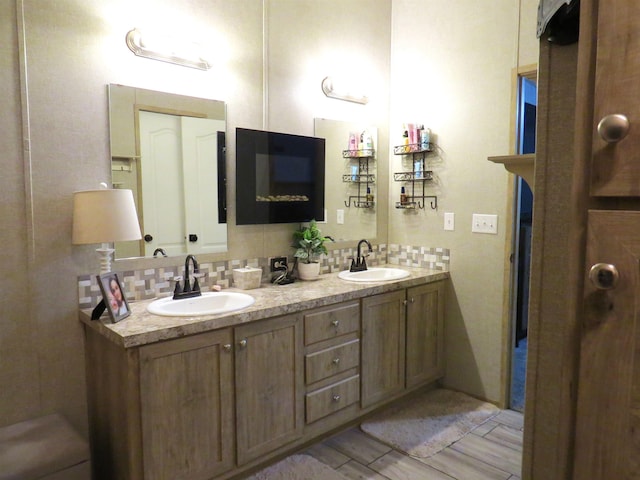 14547 Oak Leaf Loop, Splendora, TX 77372 - full bathroom featuring double vanity and decorative backsplash