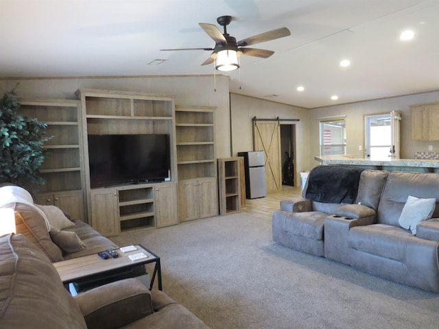14547 Oak Leaf Loop, Splendora, TX 77372 - living area with a barn door, vaulted ceiling, recessed lighting, a ceiling fan, and light carpet