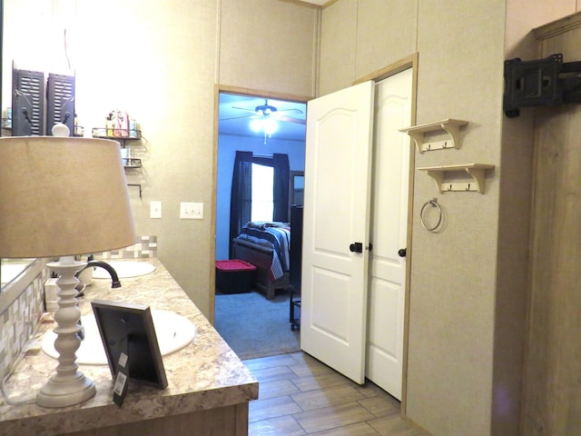14547 Oak Leaf Loop, Splendora, TX 77372 - bathroom with wood finished floors, ceiling fan, double vanity, and a high ceiling