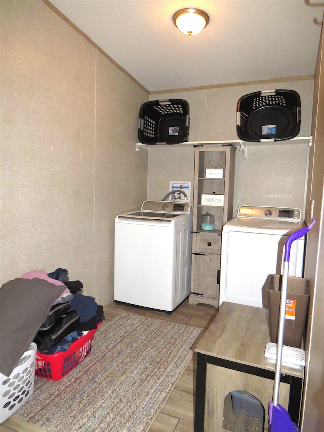 14547 Oak Leaf Loop, Splendora, TX 77372 - laundry area with washer and clothes dryer and light wood-type flooring
