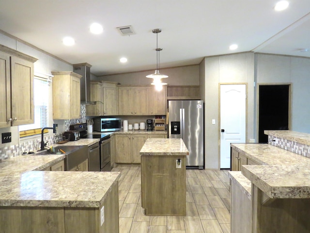 14547 Oak Leaf Loop, Splendora, TX 77372 - kitchen featuring appliances with stainless steel finishes, wall chimney exhaust hood, a kitchen island, a sink, and lofted ceiling