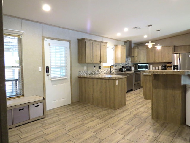 14547 Oak Leaf Loop, Splendora, TX 77372 - kitchen featuring appliances with stainless steel finishes, a sink, a peninsula, light countertops, and wood finish floors